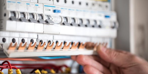 man-electrical-technician-working-switchboard-with-fuses-installation-connection-electrical-equipment-close-up-scaled[1]